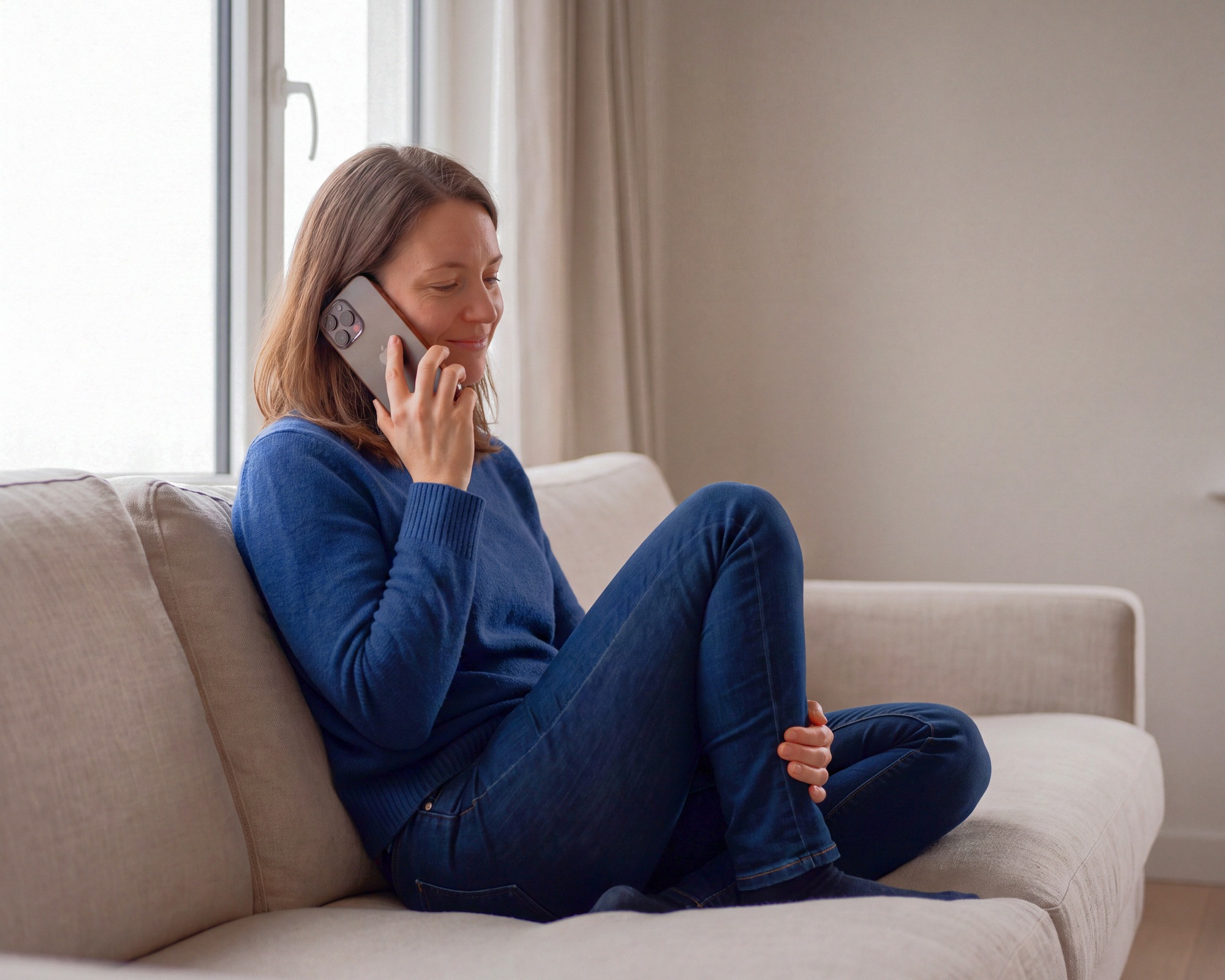 A candidate doing her interview on her phone at home